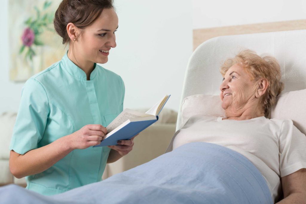 hospice volunteer reading to patient